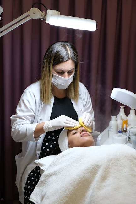 Experienced cosmetologist performing a facial treatment on a client in a spa setting.